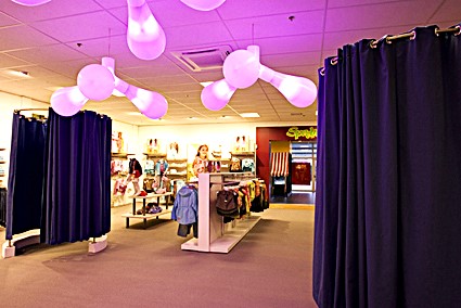 Store interior with balloon lighting and deep purple curtains